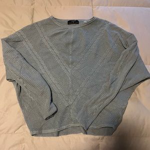 blue cropped sweater comes in at arms